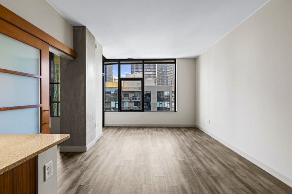 Contemporary living room with sleek furniture and large windows in Via 6 Apartments
