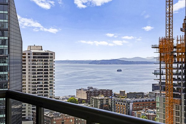 Outdoor living space with modern seating on a patio at Via 6 Apartments in Seattle, enhancing urban lifestyle with luxury amenities