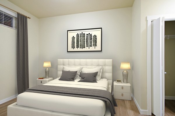 Cozy bedroom with modern decor at Chelsea Heights Apartments, featuring a comfortable queen-sized bed and stylish furnishings