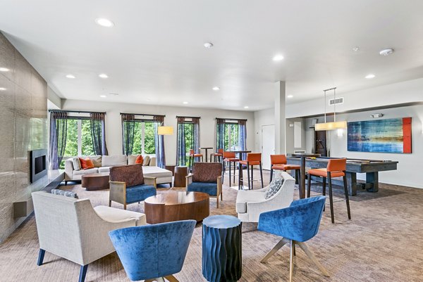 Clubhouse with modern design and cozy seating at Allez Apartments
