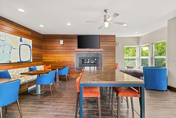 Clubhouse with modern furnishings at Allez Apartments, featuring luxury amenities for social gatherings in a vibrant community setting