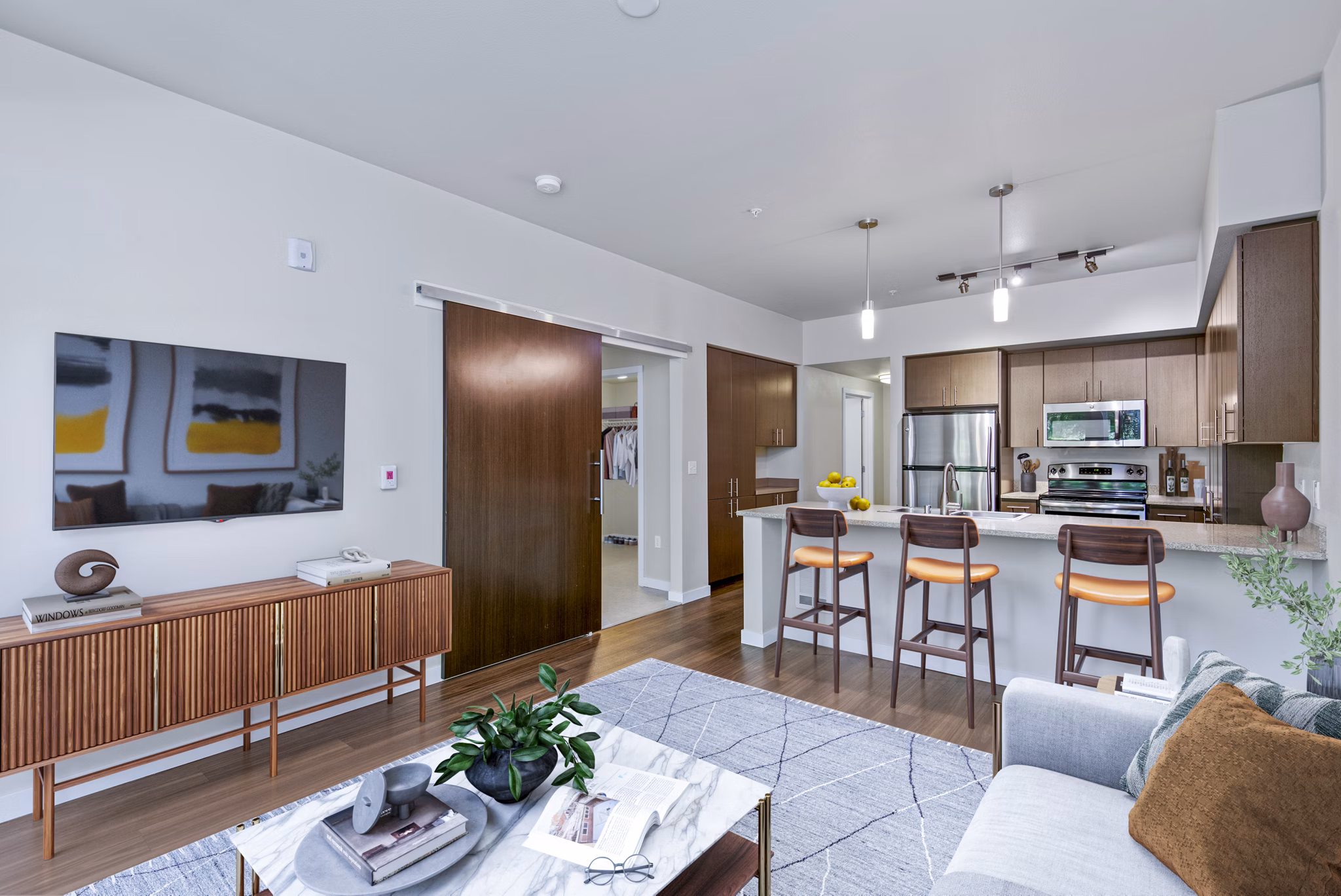 Modern kitchen featuring stainless steel appliances and sleek countertops in Allez Apartments' luxury living space
