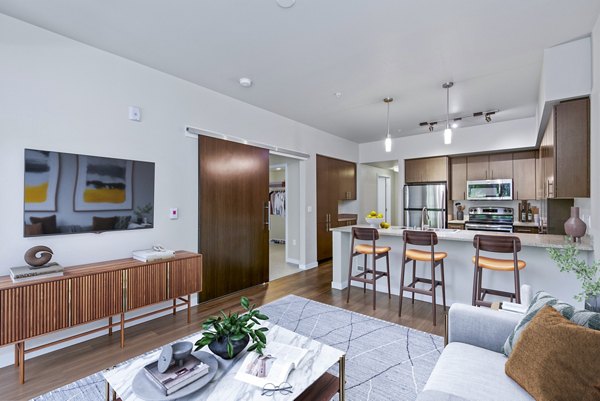 Modern kitchen featuring stainless steel appliances and sleek countertops in Allez Apartments' luxury living space