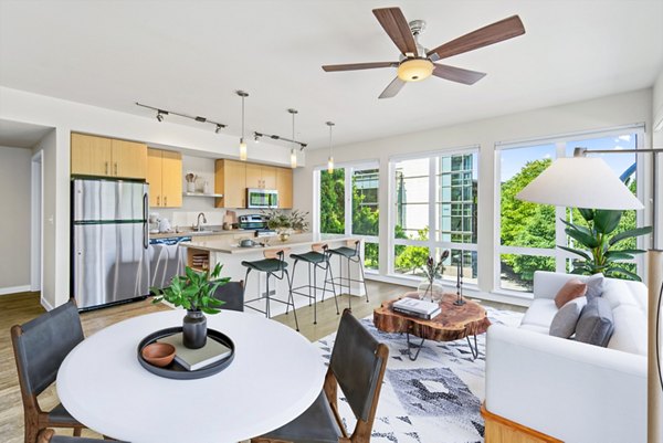 Dining room with elegant table setting and modern lighting in Allez Apartments