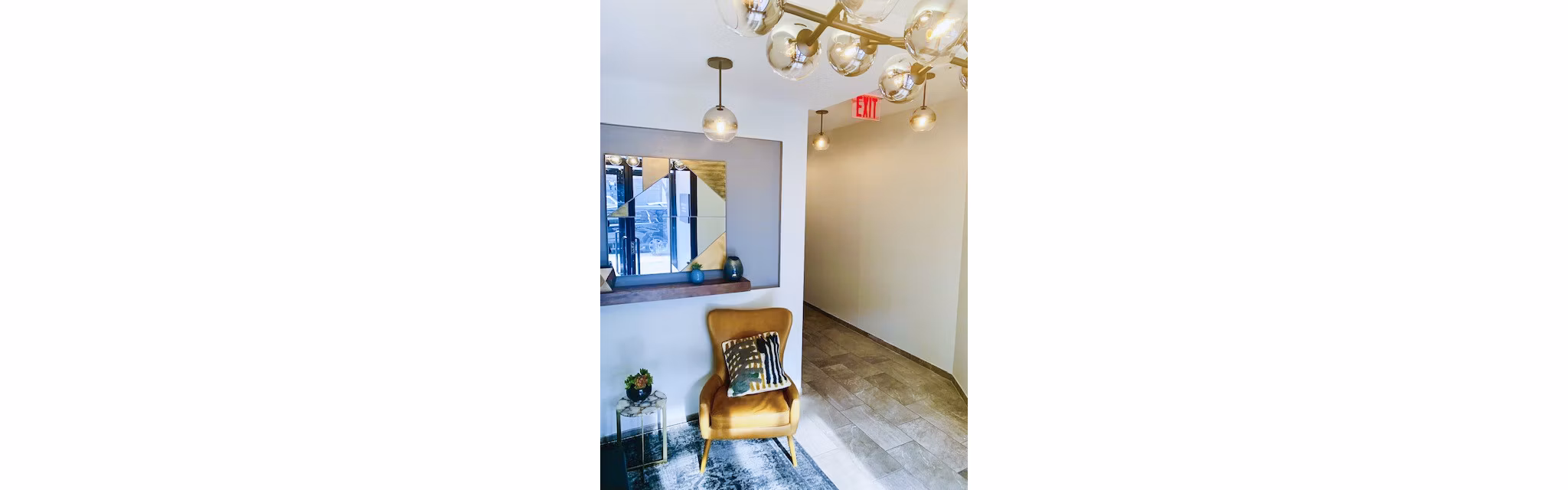 Hallway featuring exposed brick and modern lighting at The Atlantic Stamp Building Apartments in a luxury setting