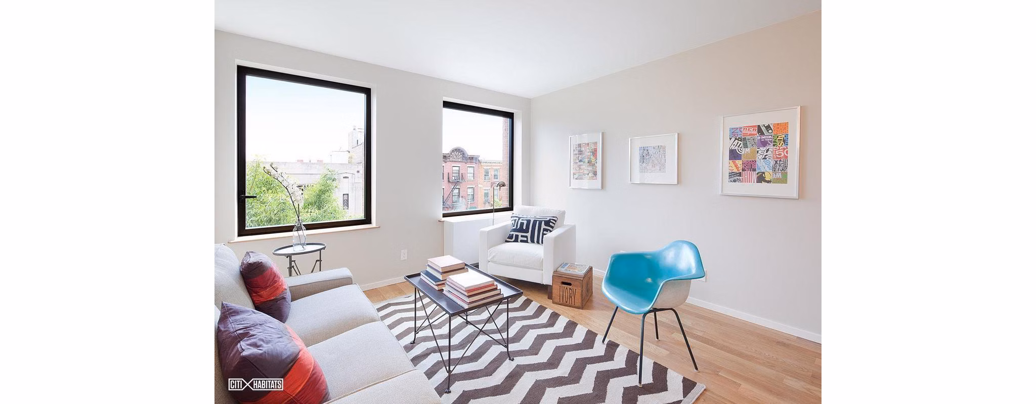 Spacious living room at The Atlantic Stamp Building Apartments featuring modern decor and large windows