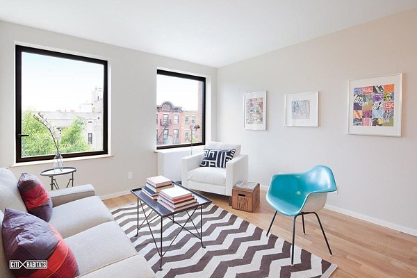 Spacious living room at The Atlantic Stamp Building Apartments featuring modern decor and large windows