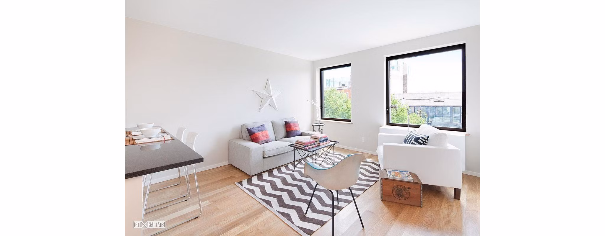 Elegant living room with exposed brick and modern dÃ©cor in The Atlantic Stamp Building Apartments, luxury homes by Greystar