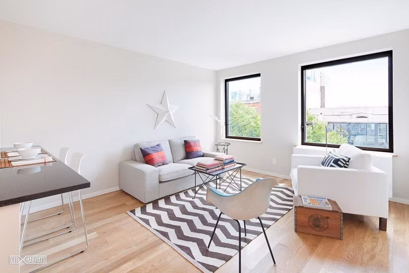 Elegant living room with exposed brick and modern dÃ©cor in The Atlantic Stamp Building Apartments, luxury homes by Greystar