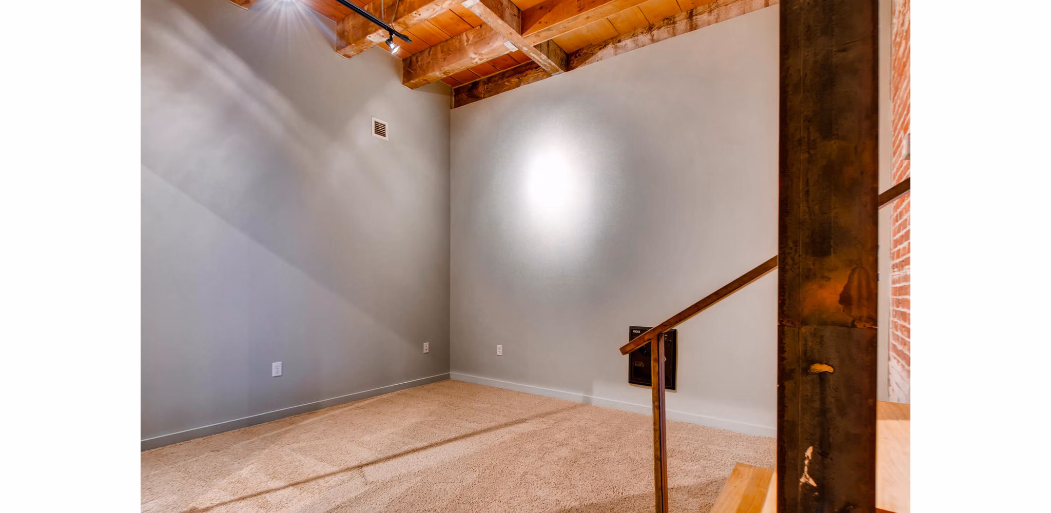 Cozy bedroom with exposed brick walls and modern furnishings in Albers Mill Lofts Apartments