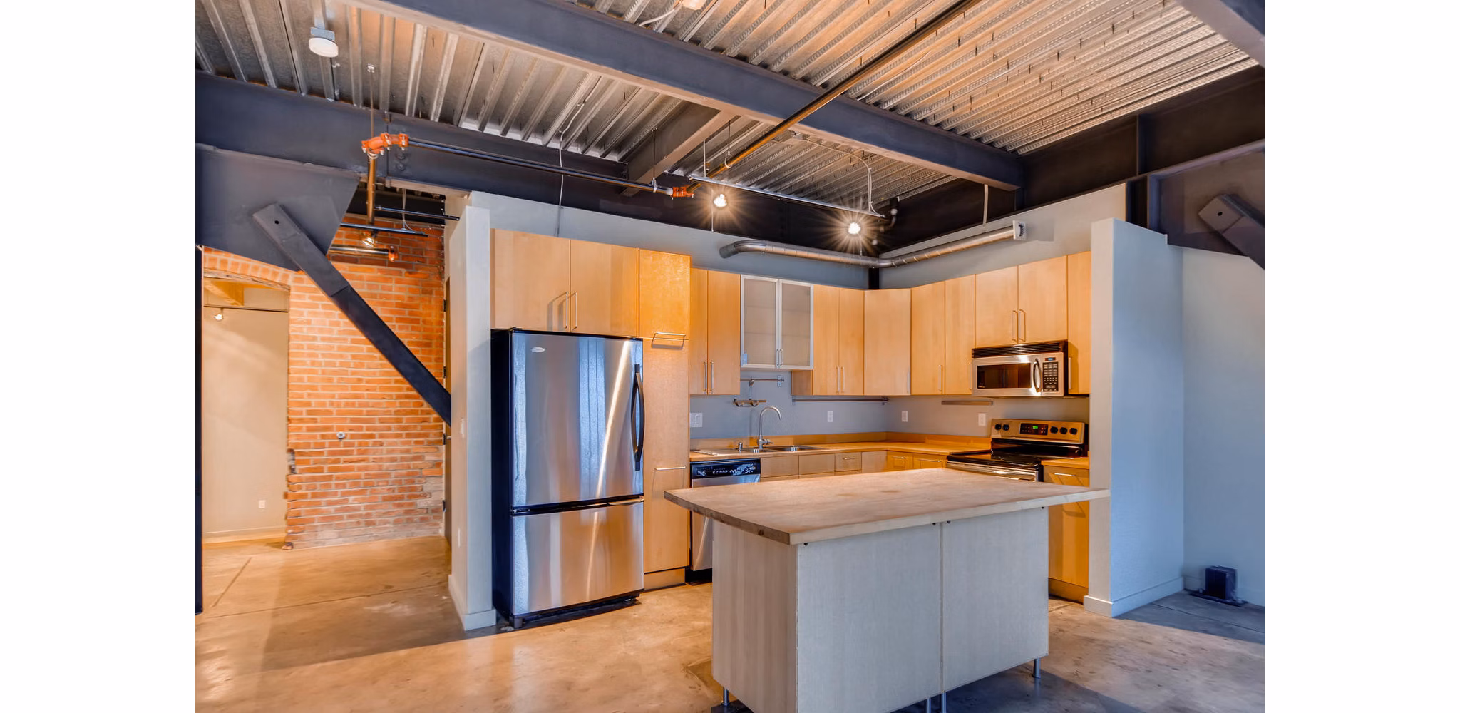 Modern kitchen with stainless steel appliances in Albers Mill Lofts Apartments