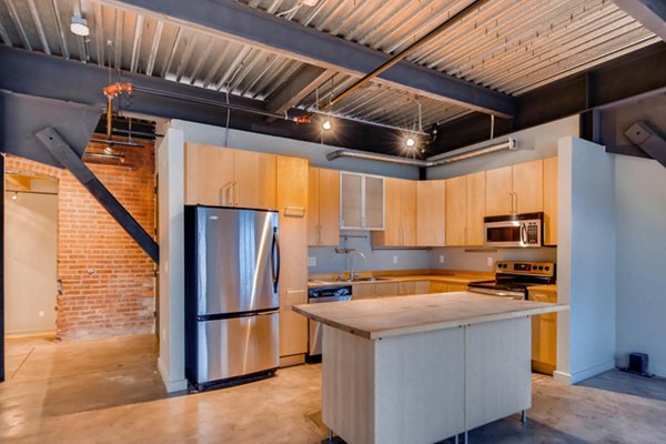 Modern kitchen with stainless steel appliances in Albers Mill Lofts Apartments