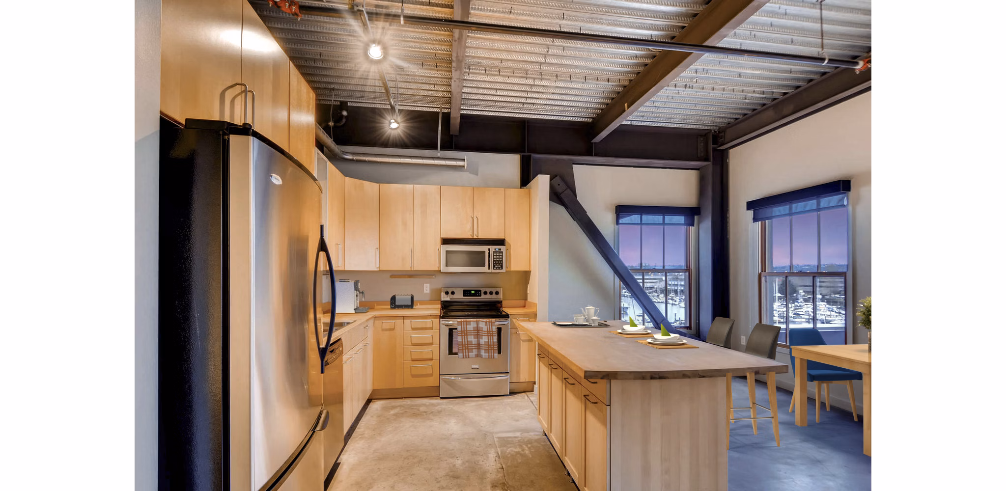 Modern kitchen featuring stainless steel appliances and granite countertops at Albers Mill Lofts Apartments Located in vibrant waterfront area