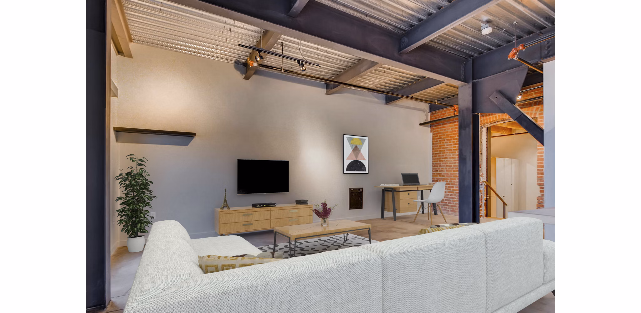 Charming living room with exposed brick and timber beams in Albers Mill Lofts Apartments