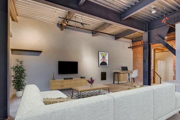 Charming living room with exposed brick and timber beams in Albers Mill Lofts Apartments