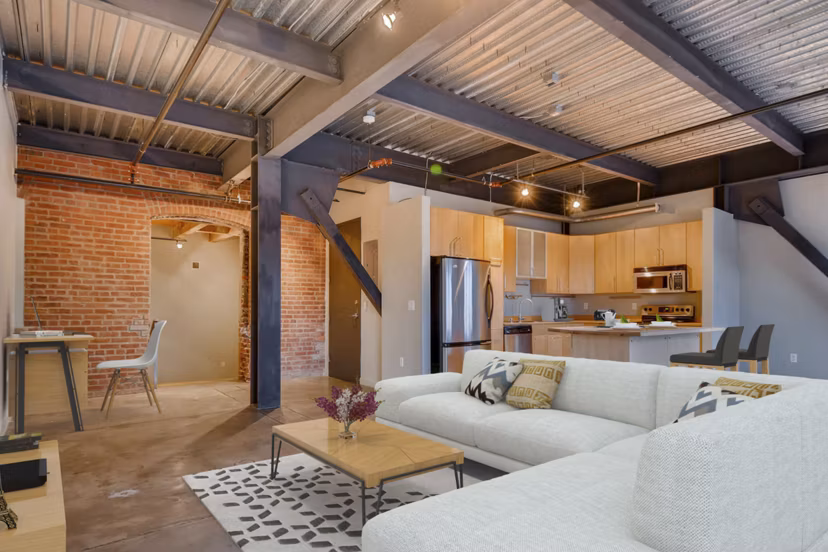 Cozy living room with exposed brick walls in Albers Mill Lofts Apartments