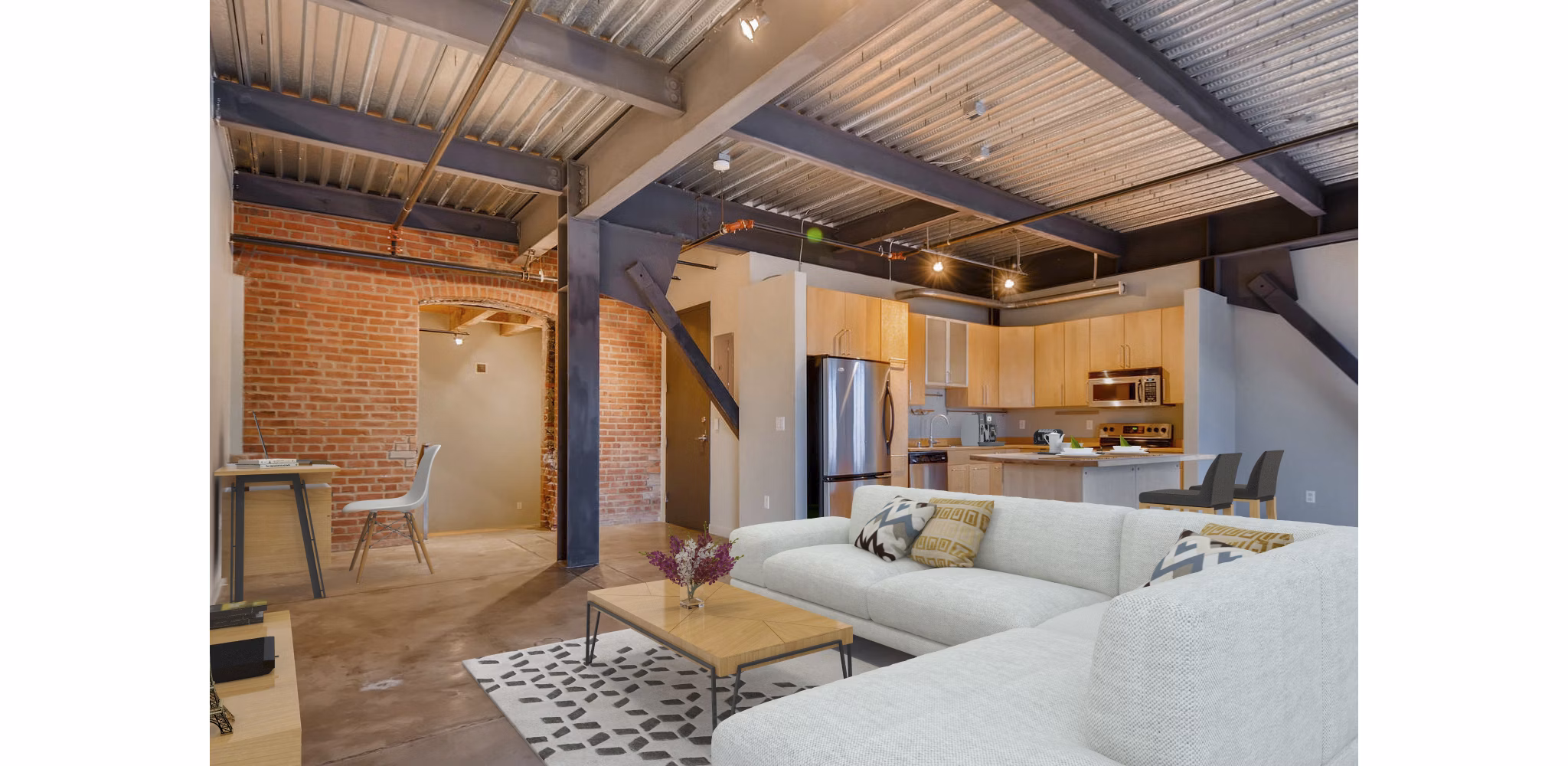 Cozy living room with exposed brick walls in Albers Mill Lofts Apartments