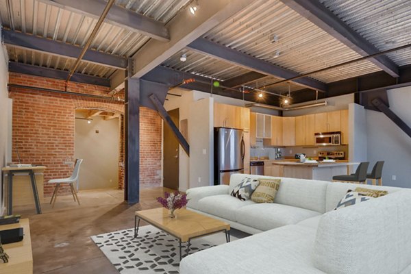 Cozy living room with exposed brick walls in Albers Mill Lofts Apartments