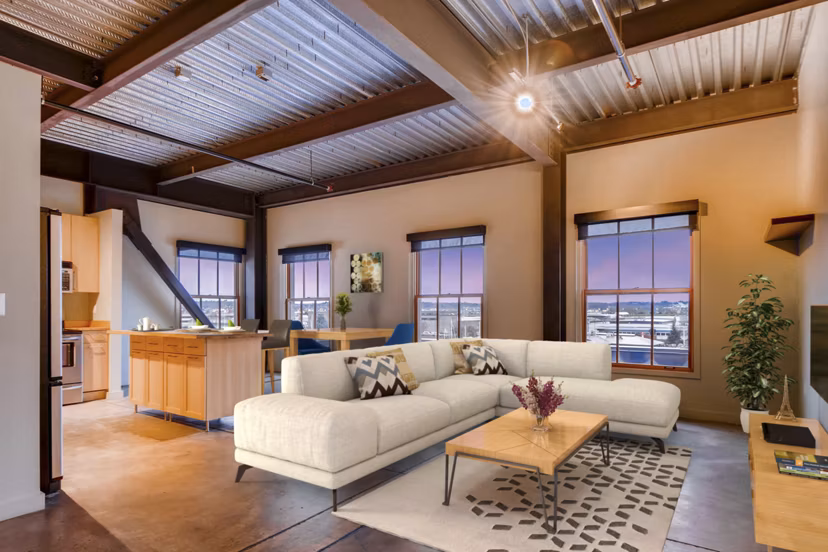Spacious living room with exposed brick and modern decor in Albers Mill Lofts Apartments in luxury Greystar property
