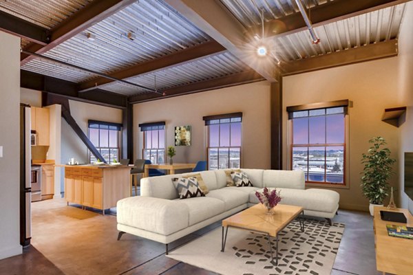 Spacious living room with exposed brick and modern decor in Albers Mill Lofts Apartments in luxury Greystar property