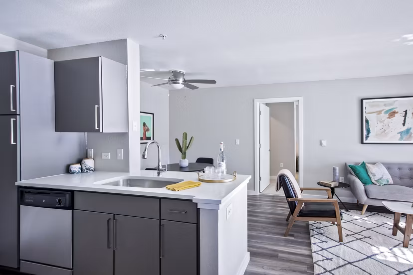 Modern kitchen with granite countertops and stainless steel appliances at Seven West at the Trails Apartments in Greystar's luxury community
