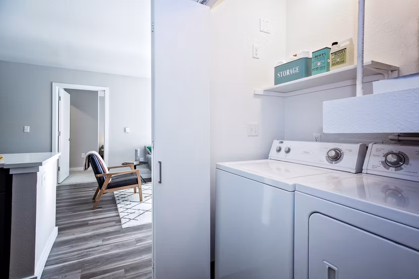 Laundry room with modern appliances at Seven West at the Trails Apartments