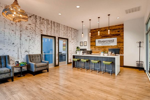 Clubhouse in Rivercrest Meadows Apartments featuring modern design and ample seating Perfect for social gatherings and community events