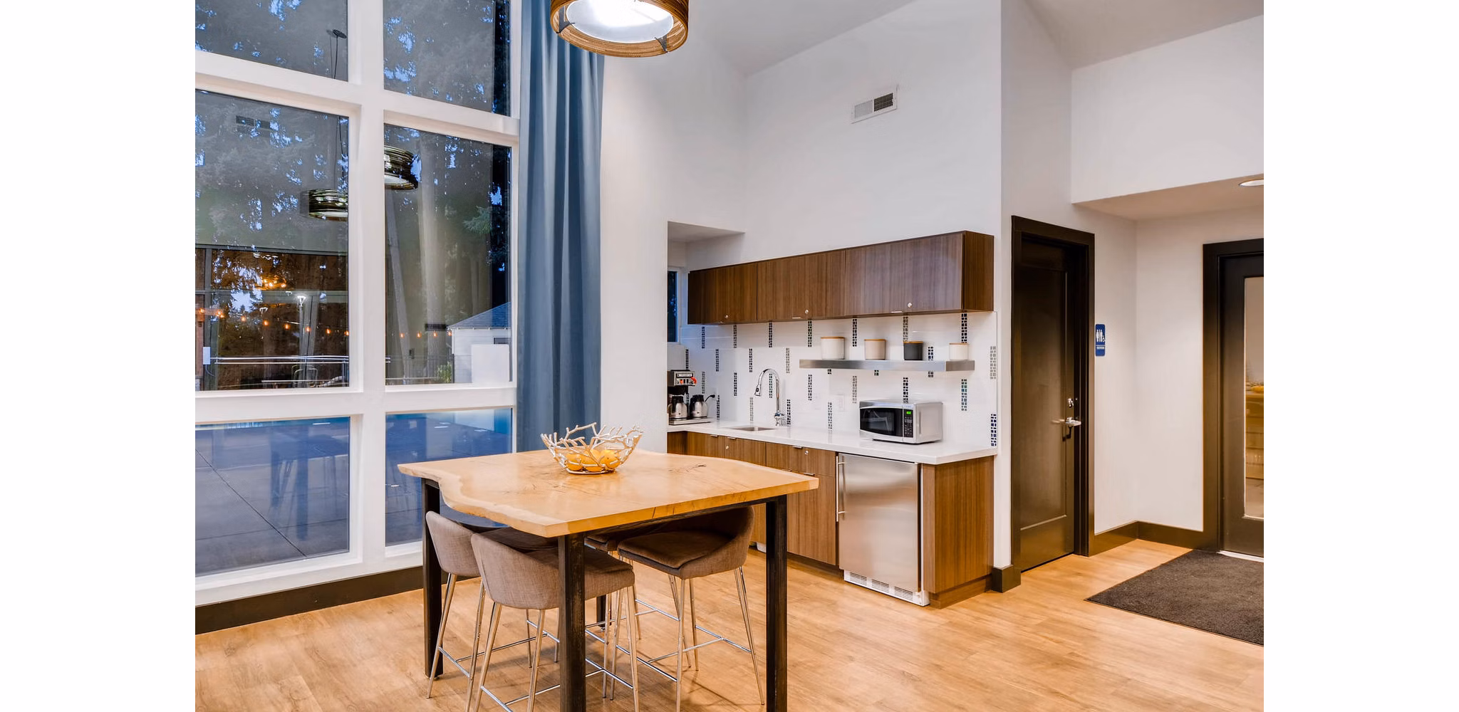 Clubhouse featuring modern design and ample seating at Rivercrest Meadows Apartments