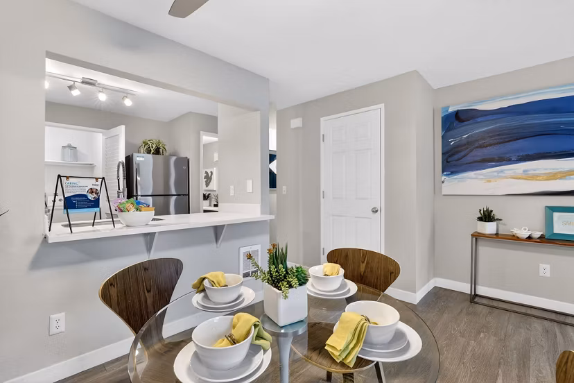 Dining room featuring elegant wooden table and modern lighting at Rivercrest Meadows Apartments