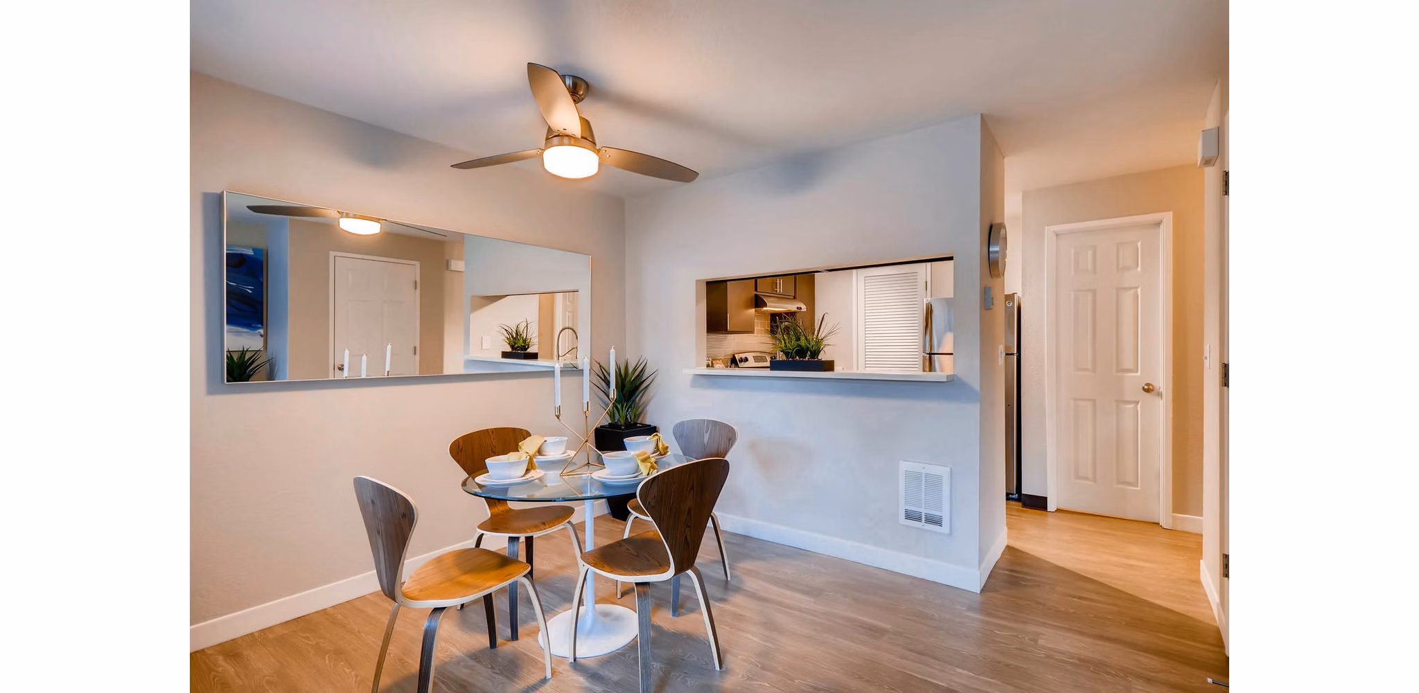 Dining room featuring elegant wooden table and modern lighting at Rivercrest Meadows Apartments