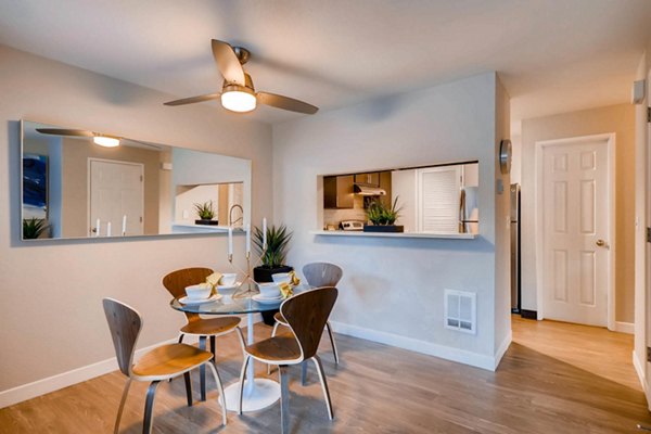 Dining room featuring elegant wooden table and modern lighting at Rivercrest Meadows Apartments