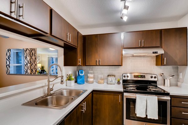 Modern kitchen with stainless steel appliances at Rivercrest Meadows Apartments