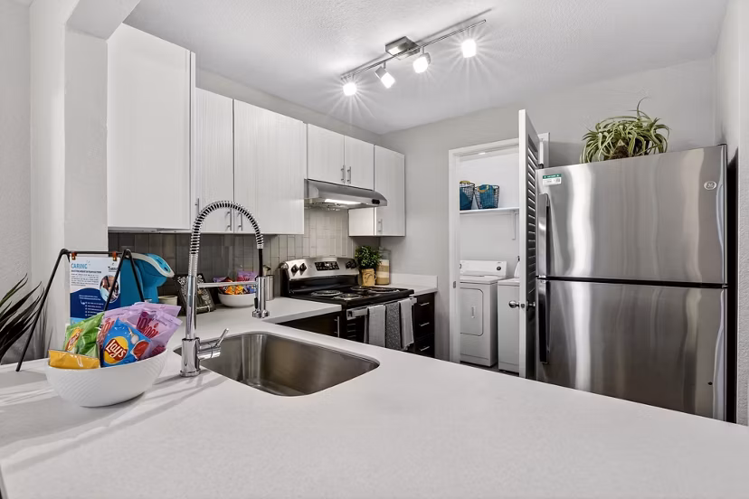 Modern kitchen with stainless steel appliances in Rivercrest Meadows Apartments