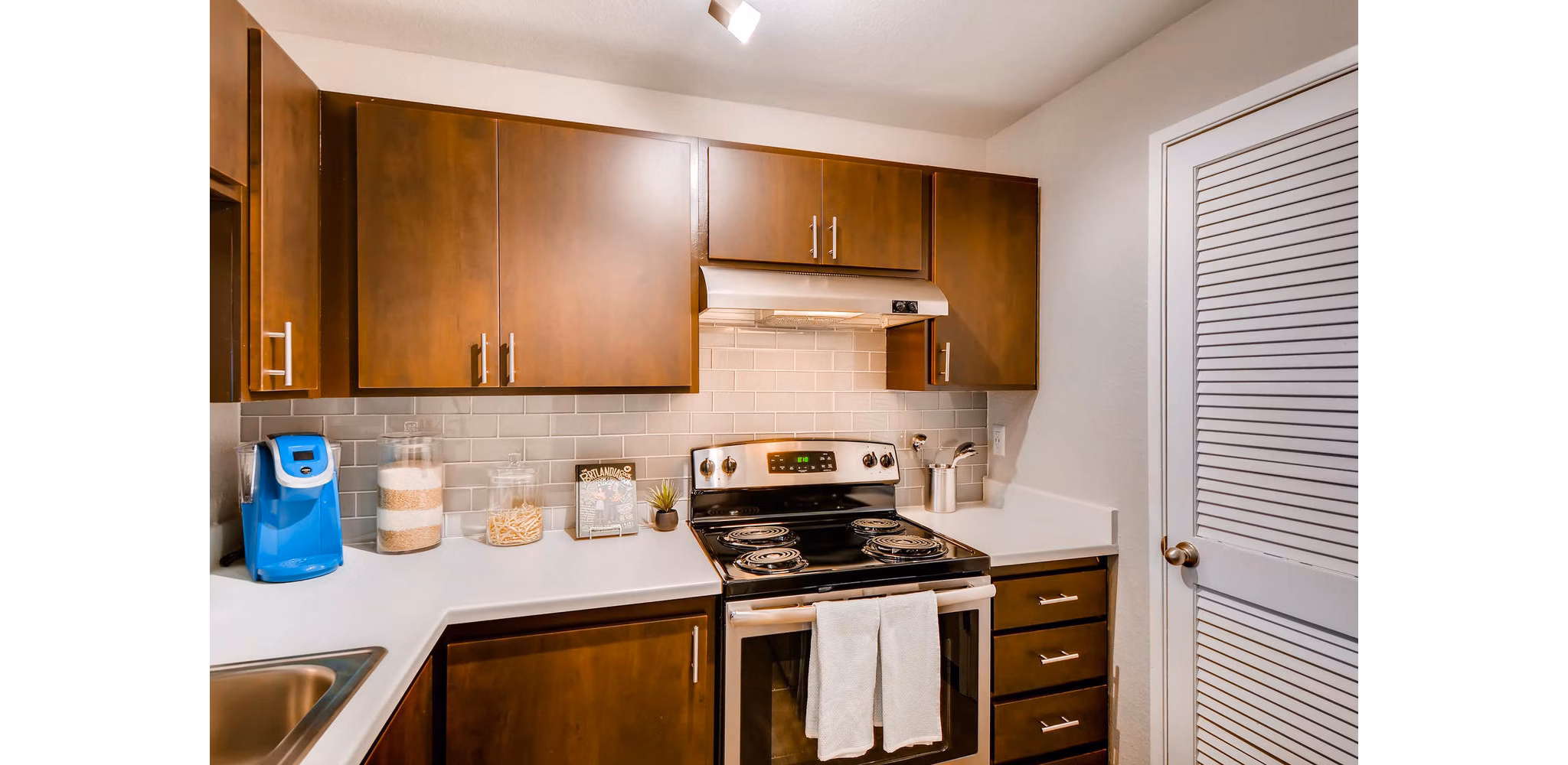 Modern kitchen with stainless steel appliances in Rivercrest Meadows Apartments