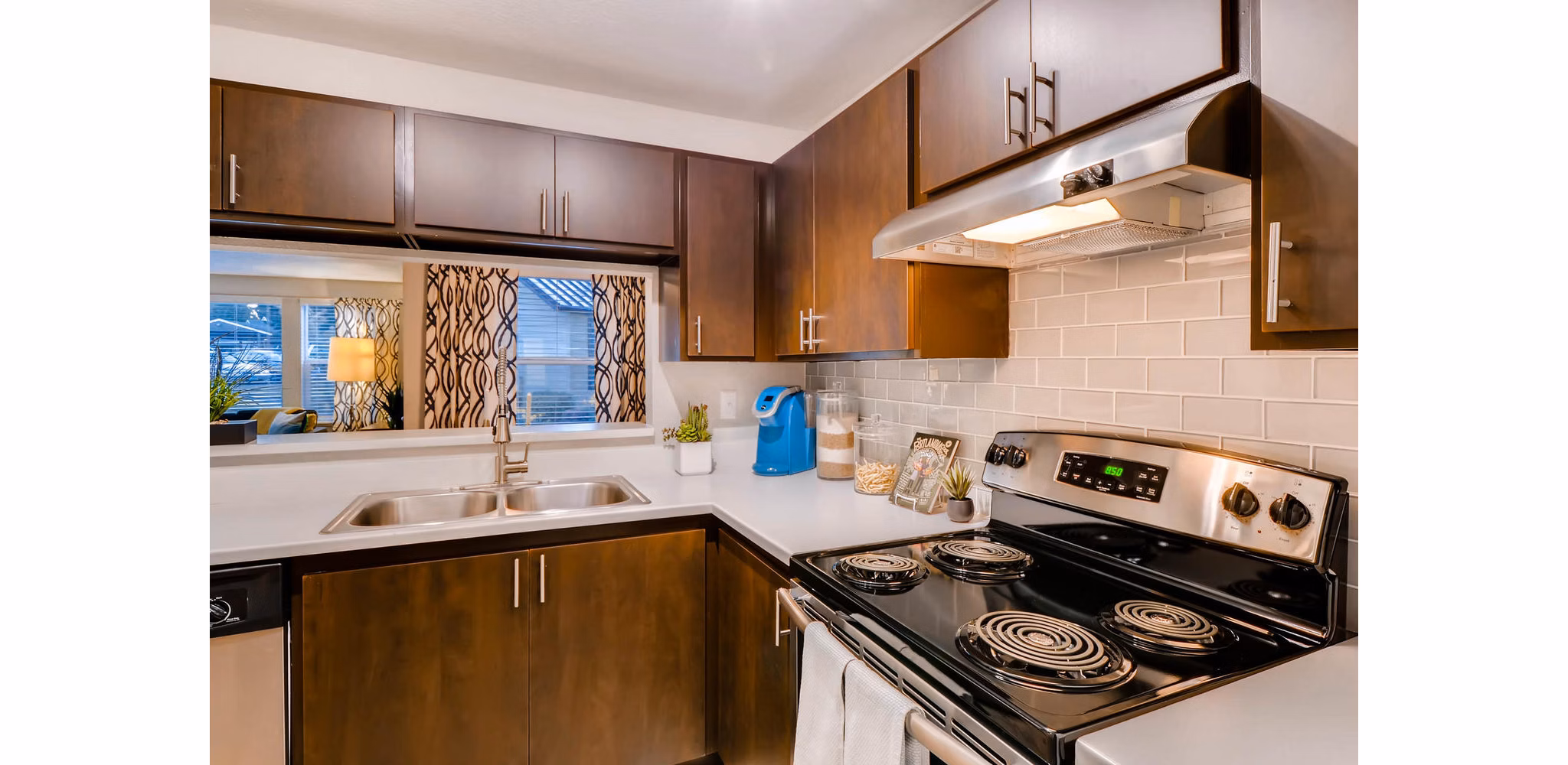 Modern kitchen with stainless steel appliances at Rivercrest Meadows Apartments