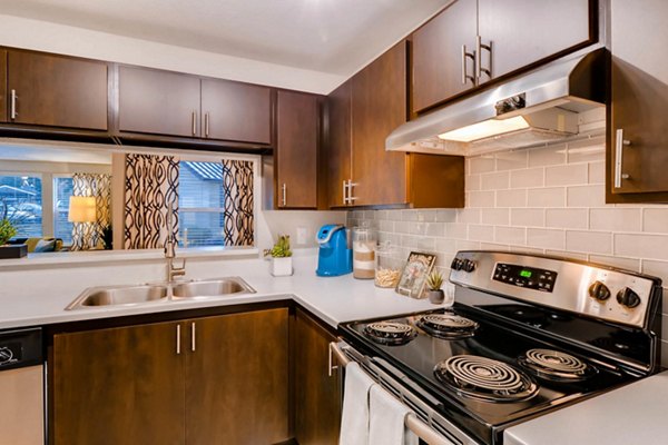 Modern kitchen with stainless steel appliances at Rivercrest Meadows Apartments