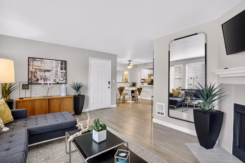 Spacious living room with plush seating and large windows at Rivercrest Meadows Apartments, luxury living space ideal for relaxation