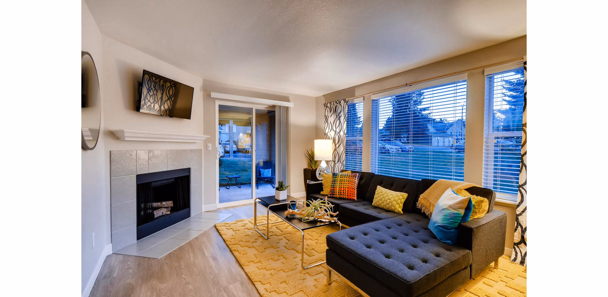 Spacious living room with plush seating and large windows at Rivercrest Meadows Apartments, luxury living space ideal for relaxation