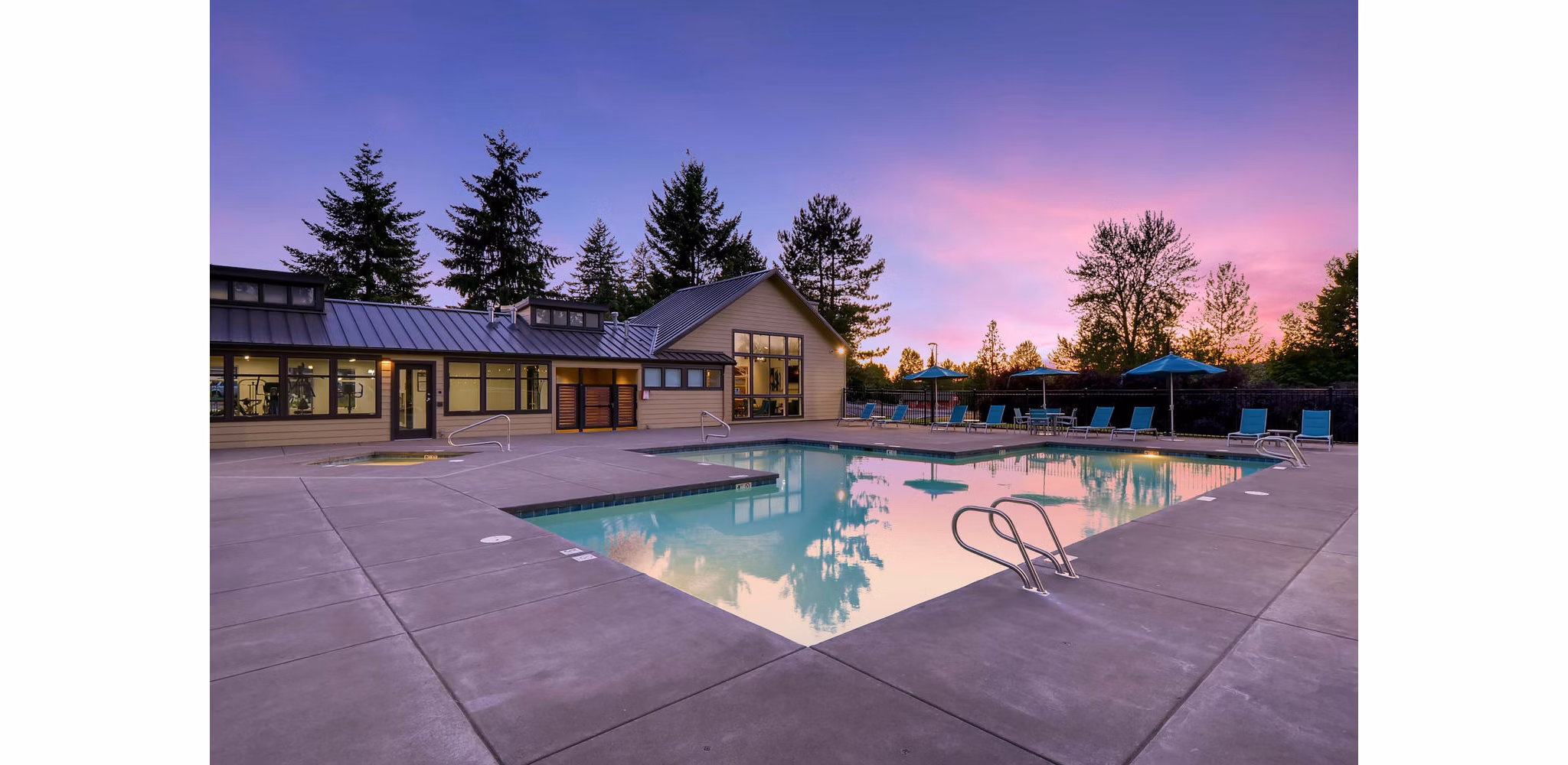 Outdoor swimming pool with sundeck at Rivercrest Meadows Apartments, offering luxury relaxation and leisure for residents