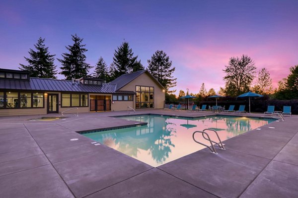 Outdoor swimming pool with sundeck at Rivercrest Meadows Apartments, offering luxury relaxation and leisure for residents