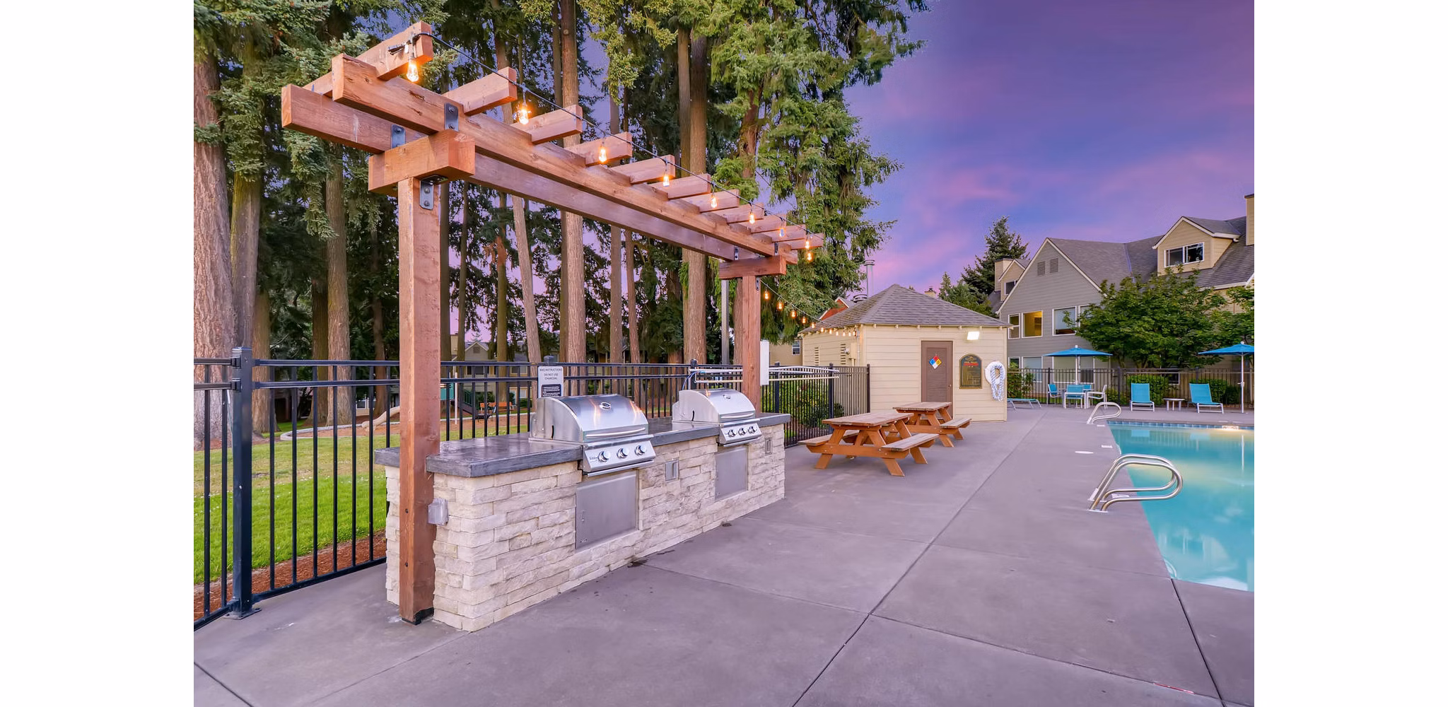Grill area with outdoor seating at Rivercrest Meadows Apartments, perfect for socializing and dining al fresco