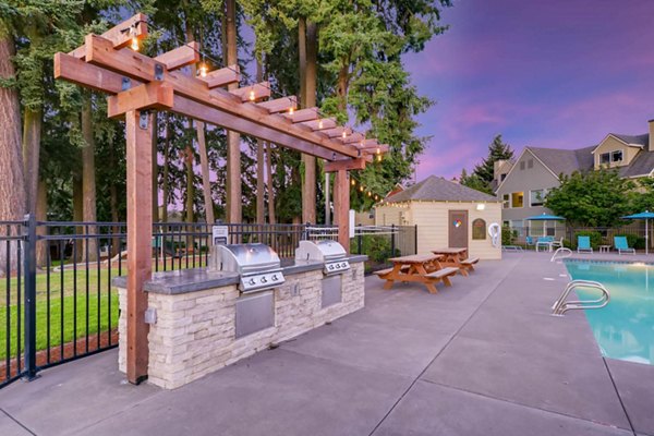 Grill area with outdoor seating at Rivercrest Meadows Apartments, perfect for socializing and dining al fresco