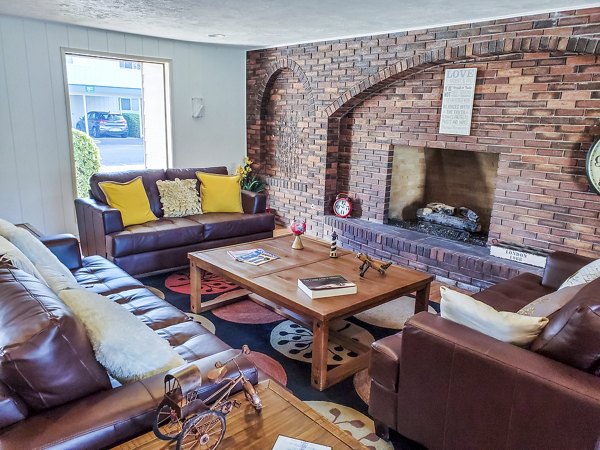Modern clubhouse with leisure seating and entertainment area at Meadowlawn Apartments