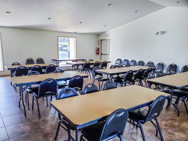 Clubhouse dining room with elegant seating and decor at Meadowlawn Apartments