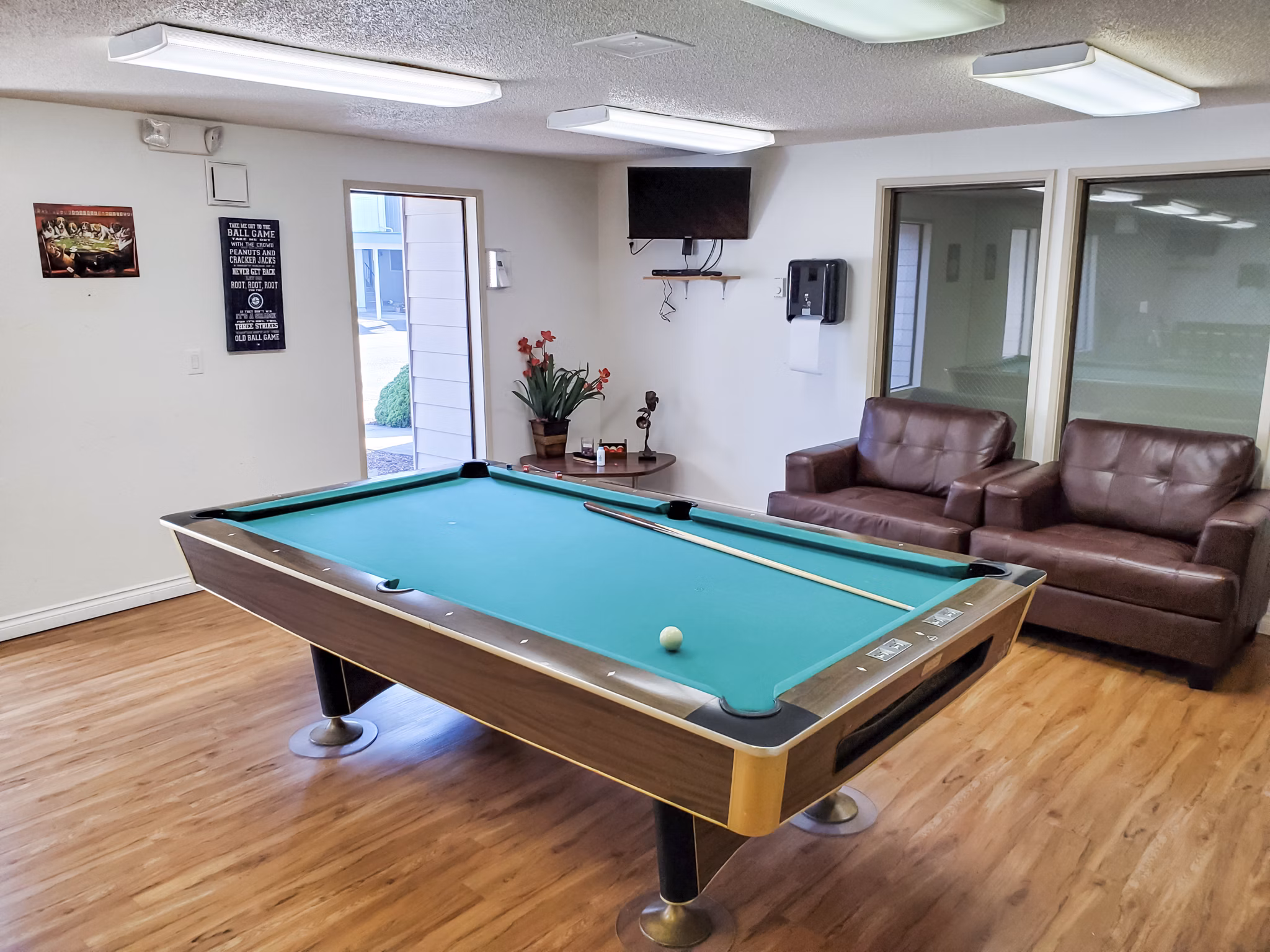 Clubhouse game room with billiards and modern decor at Meadowlawn Apartments, luxury community by Greystar