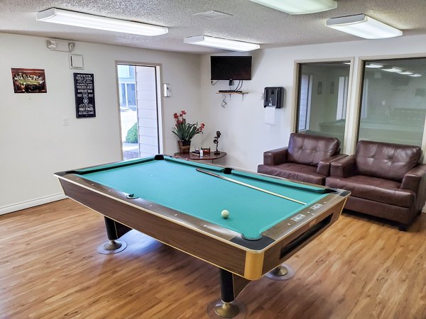 Clubhouse game room with billiards and modern decor at Meadowlawn Apartments, luxury community by Greystar