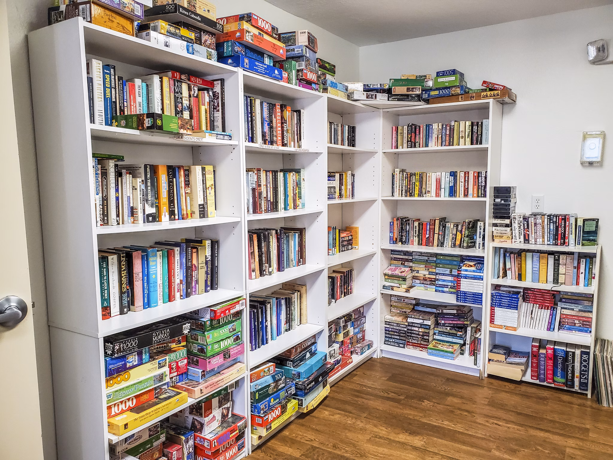 Cozy clubhouse library featuring plush seating and bookshelves at Meadowlawn Apartments, perfect for reading and relaxation