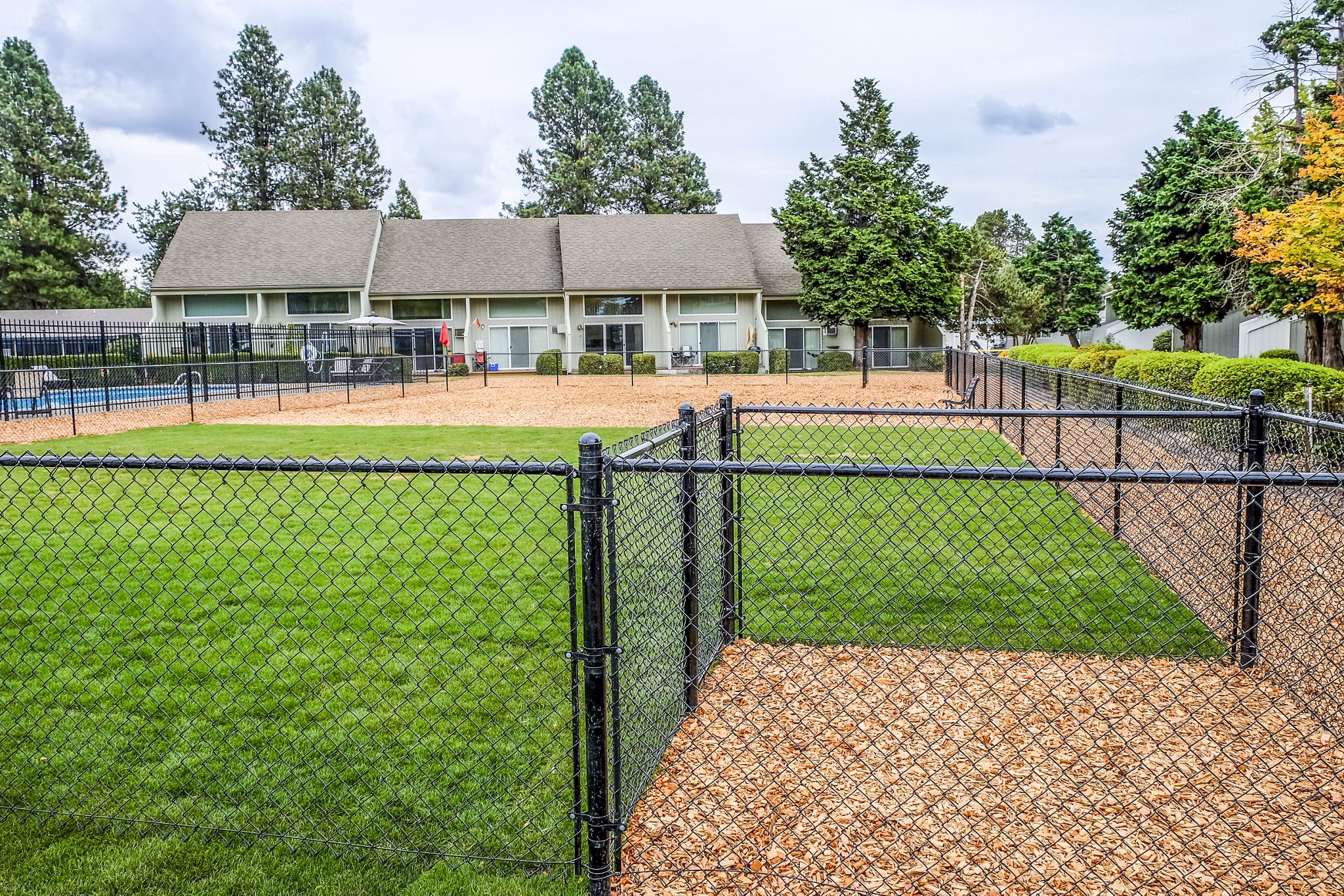 Dog park at Meadowlawn Apartments featuring agility equipment and open play areas for pets