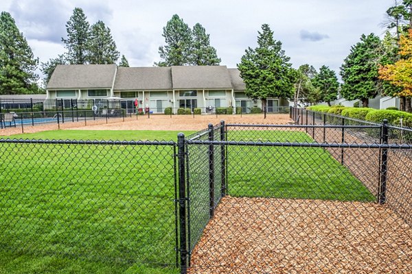 Dog park at Meadowlawn Apartments featuring agility equipment and open play areas for pets