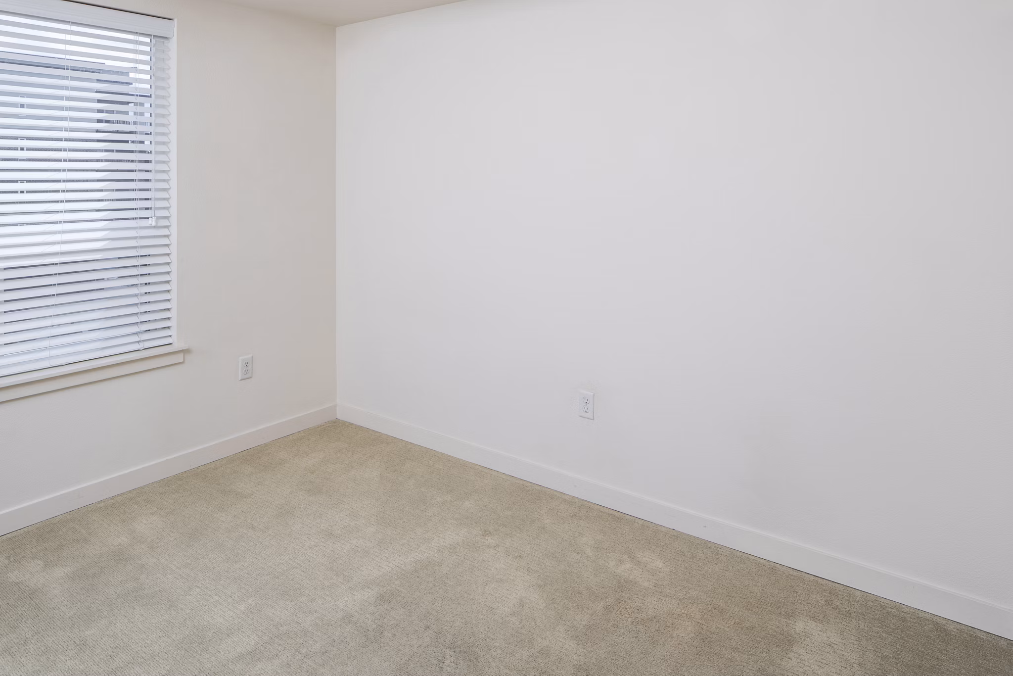 Cozy bedroom with modern furnishings at The Felix Apartments, a Greystar property known for luxury living